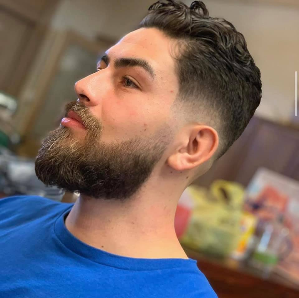 Fade haircut with a fresh beard trim and edge, long and lushous. 